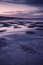 Vibrant sunrise landscape reflected in low tide water on beach Royalty Free Stock Photo