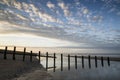 Vibrant sunrise landscape reflected in low tide water on beach Royalty Free Stock Photo