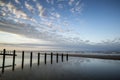 Vibrant sunrise landscape reflected in low tide water on beach Royalty Free Stock Photo