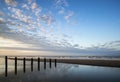 Vibrant sunrise landscape reflected in low tide water on beach Royalty Free Stock Photo