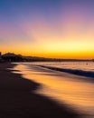 A vibrant sunrise with light reflecting in waves on the coastline of Cabo San Lucas Royalty Free Stock Photo