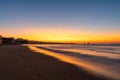 A vibrant sunrise with light reflecting in waves on the coastline of Cabo San Lucas Royalty Free Stock Photo