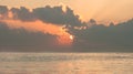 Vibrant sunrise over the sea with clouds and sunbeams