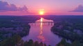 Vibrant sunset over a serene river valley with a bridge, tranquil colors Royalty Free Stock Photo