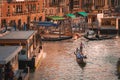 Vibrant Sunset Scene with Gondolas Gliding Through Venice Canal, Italy Royalty Free Stock Photo