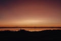 Vibrant sunset sky over Tuggerah Lake from Canton Beach in Toukley, NSW Australia Royalty Free Stock Photo