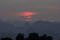 Vibrant sunset from Tiger Cave Temple (Wat Tham Suea) in Krabi, Thailand. Clouds around the sun looking like Saturn Royalty Free Stock Photo