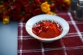 Vibrant table setting, featuring chili powder and red peppers arrangement