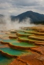 Vibrant Terraces of Steaming Hot Springs with Mountain Backdrop AI-GENERATED Royalty Free Stock Photo