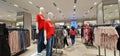 A Vibrant textile store in Mumbai during sale time, female mannequins flaunting red SALE tees