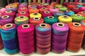vibrant threads on spools ready for carpet weaving