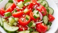 A vibrant tomato and cucumber salad, bursting with fresh colors