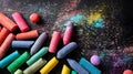 Dynamic top view of vibrant chalk pieces and colorful dust scattered on a dark surface. Royalty Free Stock Photo