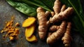 Vibrant turmeric root, slices, and powder on dark stone Royalty Free Stock Photo
