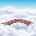 A vibrant, twisting structure resembling DNA spans across fluffy clouds in a clear blue Royalty Free Stock Photo