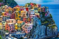 A vibrant village built on the edge of a cliff, providing sweeping views of the ocean, A colorful Italian coastal village, AI