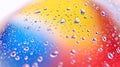 Vibrant water droplets on colorful gradient surface Royalty Free Stock Photo