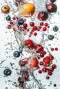 Vibrant water splash with fruits and berries on white background Royalty Free Stock Photo