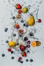 Vibrant water splash with fruits and berries on white background Royalty Free Stock Photo
