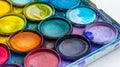 Vibrant watercolor paints in a palette, showing rich pigments and use