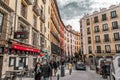 A vibrant weekend morning on the Calle Cava de San Miguel, Madrid, Spain