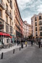 A vibrant weekend morning on the Calle Cava de San Miguel, Madrid, Spain