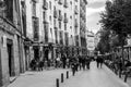 A vibrant weekend morning on the Calle Cava de San Miguel, Madrid, Spain