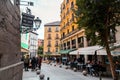 A vibrant weekend morning on the Calle Cava de San Miguel, Madrid, Spain
