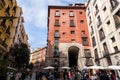 A vibrant weekend morning on the Calle Cava de San Miguel, Madrid, Spain