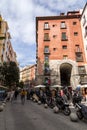 A vibrant weekend morning on the Calle Cava de San Miguel, Madrid, Spain