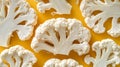 Vibrant White Cauliflower Florets on a Bright Yellow Background, Textured Vegetable Pattern. Royalty Free Stock Photo