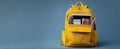 The vibrant yellow backpack filled with stationery and learning supplies..AI generated image Royalty Free Stock Photo