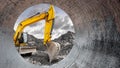 A vibrant yellow excavator works diligently at a construction site, digging into the earth while framed by a cylindrical pipe Royalty Free Stock Photo