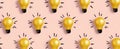 The vibrant yellow lightbulbs illuminating a playful pink background pattern. AI generated image Royalty Free Stock Photo