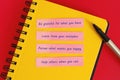 Vibrant Yellow Notebook with Handwritten Life Lessons and Pen on Red Background