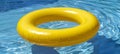 Vibrant yellow pool float in crystal blue swimming pool, perfect for a refreshing summer concept