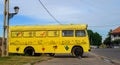 Vibrant yellow skin tourist bus parked on Galle fort, colorful drawings on the bus body Royalty Free Stock Photo