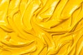 A vibrant yellow smooth texture and dynamic movement of mustard as background Royalty Free Stock Photo