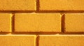 Vibrant yellow textured brick wall pattern showcasing warm sunlight casting dynamic shadows for a bold architectural design Royalty Free Stock Photo