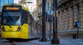 Vibrant yellow tram in the streets of Manchester, UK. Royalty Free Stock Photo