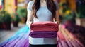 Vibrant young woman rolling colorful yoga mat at home for invigorating exercise and relaxation Royalty Free Stock Photo