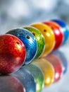 Vibrantly colored bowling balls arranged in a diagonal line with reflections on a glossy surface creating a visually striking Royalty Free Stock Photo