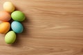 Vibrantly colored Easter eggs are artistically arranged in a beautiful display on a rustic wooden surface, celebrating Royalty Free Stock Photo