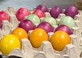 Vibrantly colored eggs arranged in a carton display easter variety Royalty Free Stock Photo