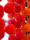 Vibrantly Colored Pompoms Hanging in a Shop Window