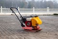 Vibrating plate compactor machine at a construction site. Equipment for soil thrombosis. Compaction work on sand, earth or asphalt Royalty Free Stock Photo