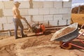 Vibrating plate in use, the worker with the help of a vibrating plate compacts the sand, building a house Royalty Free Stock Photo