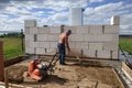 Vibrating plate in use, the worker with the help of a vibrating plate compacts the sand, building a house Royalty Free Stock Photo