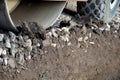 The vibrating roller compresses the aggregate and concrete gravel fragments. it can also roll asphalt. close-up view of a tire and