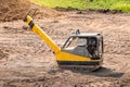Ramming machine for compaction of soil at construction site when laying a road Royalty Free Stock Photo
